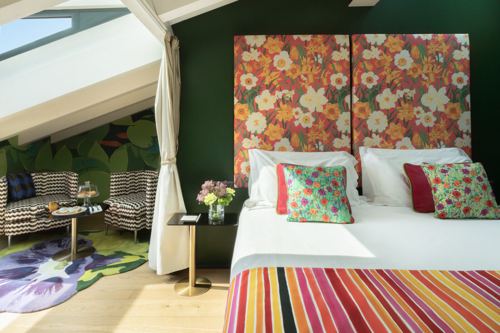 An attic suite at Speronari Suites — skylights, bold florals and a private terrace